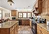 Open kitvhen with granite counter top and all the appliances you need
