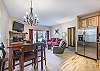 Living area, dining area, and kitchen all flow together nicely with the open floor plan.