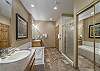 Located off the Primary bedroom with his and hers sinks, large glass shower stall, and grand soaking tub.