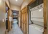 Hallway closet hosts the stack-on washer and dryer for your convenience.