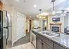 Granite counters, stainless steel appliances, pendant lighting, and a variety of kitchen utensils.
