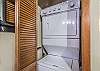 Closet with stack-on washer and dryer is located next to the kitchen.