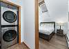 Stackable washer & dryer next to primary bedroom