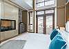 Master Bedroom with Balcony & adjoining Gas Fireplace to Ensuite Bathroom (upper floor)