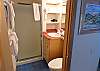 Th main level bathroom has a vanity and shower. It can be conveniently used by the first twin bedroom. 