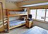 The second bedroom has a queen-sized bed and a bunk bed. This room comes with a TV and it's own private bathroom. 
