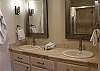 Private, master bathroom with jetted jacuzzi bath, shower and vanity.