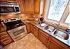 Newly remodeled, fully equipped kitchen with an open dining room area. 