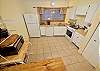 The fully equipped kitchen is sizable and has all the amenities needed for a great stay. 