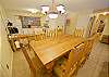 The large dining room table is wonderful for the entire party. The dining area opens up into the fully equipped kitchen and living room. 