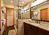 The master bathroom has a large shower and a double vanity. 