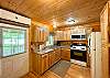 Full kitchen with beautiful wood cabinetry.