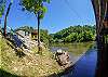 View of back of home and river in back yard. 