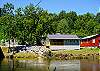 View of back of home and river in back yard. 