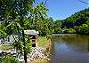 View of back of home and river in back yard. 