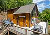 Exterior view of deck with table and seating, gas grill, and hot tub. 