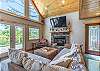 Living room with comfortable, sectional couch and gas fireplace. 