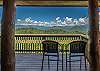 Covered deck with seating to enjoy views of the mountains