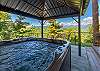 Covered hot tub with views of the mountains. 