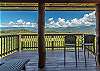 Covered deck with seating and beautiful view of mountains. 