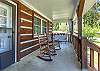 Front porch with rocking chairs and swing. 