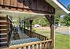 Covered porch with rocking chairs and picnic table. 