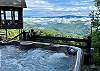 Hot tub overlooking mountain view. 