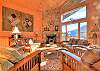 Living room with fireplace and large open windows to enjoy the view. 