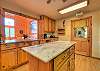 Kitchen with island and large open window looking into dining room. 