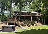 View of the side of the home and hot tub area.