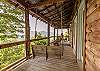 Covered porch with porch swing looking at the view 