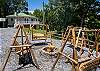 Outdoor fire pit area with wooden swings 