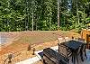 Back deck with table and seating for 6, and gas grill. 