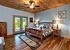 King log bedroom on lower level with patio access.