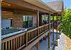 View of the upper deck from the hot tub to the seating area with the lower patio below.