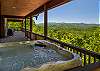 Hot tub on the covered upper deck with open views of the Mountain ridgeline.