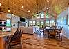Main level great room with soaring ceilings, hardwood floors, and mountain views. 
