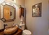 Half bath on the main level with a stone vessel sink. 