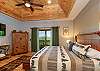 Primary suite with a king bed, and mountain views through sliding glass doors on the main level.