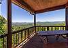 Covered deck with picnic table and beautiful mountain views.