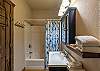 Third full bathroom located downstairs with a shower/tub combination. 
