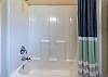 Ensuite bathroom off of the second bedroom on the main level with a shower/tub combination. 