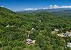 Drone shot showing the cabin nestled among the trees.
